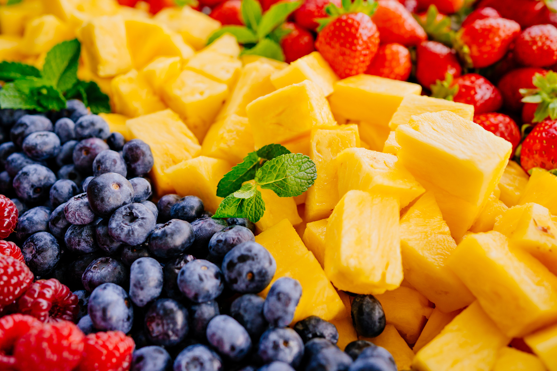 fruit assorted. raspberries, blueberries, pineapple and strawberries